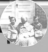 SA0187 - Eldress Lizzie with 5 year old twin girls on the front steps of a building. Identified on the back. See comment field for SA 0198.